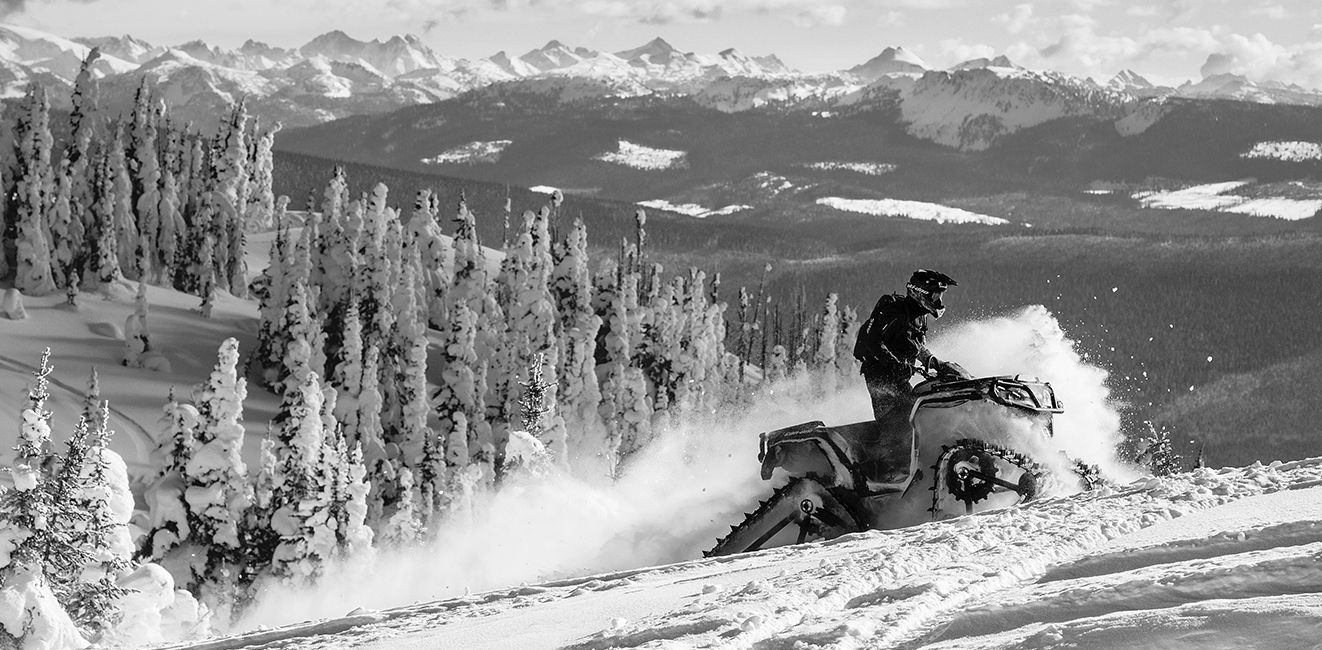 Ski-Doo snowmobile going up a snowy hill Ski-Doo snowmobile going up a snowy hill